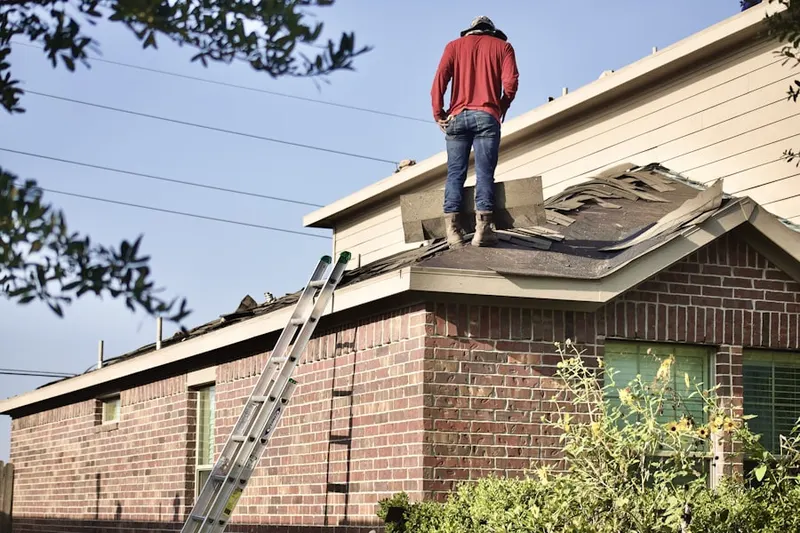 Professional roofer working on a residential roof in Cynwyd